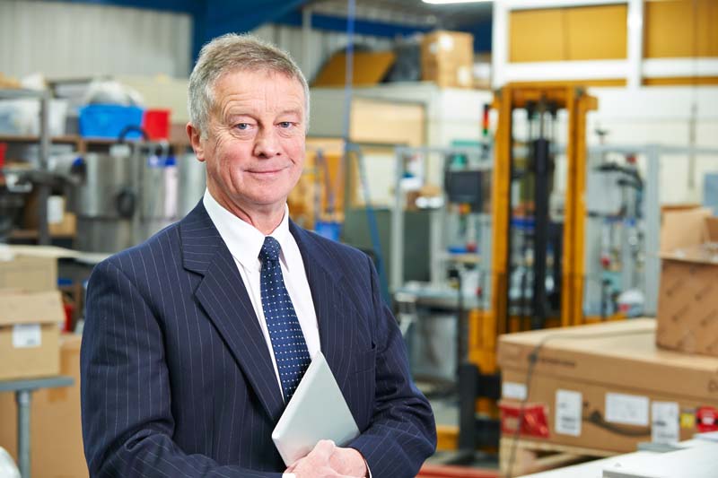 Small Business owner in blue suit in warehouse