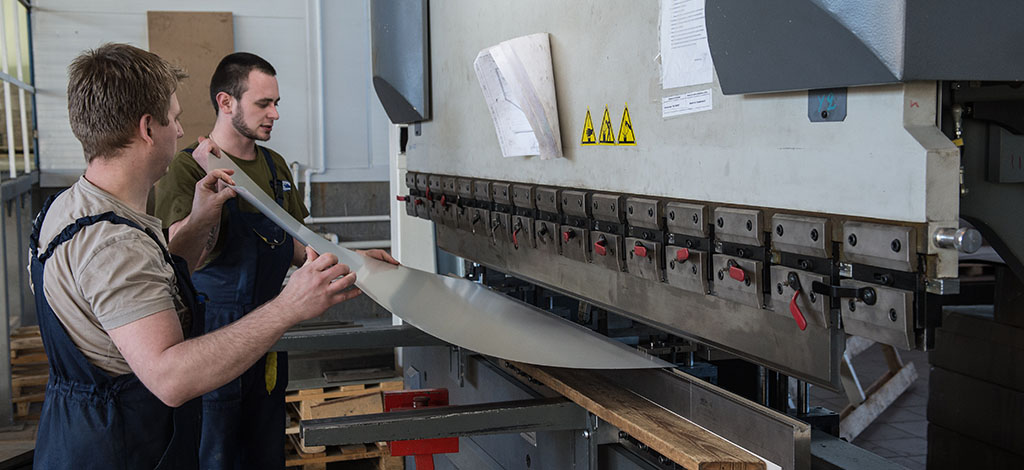 Machine Shops workers bend metal