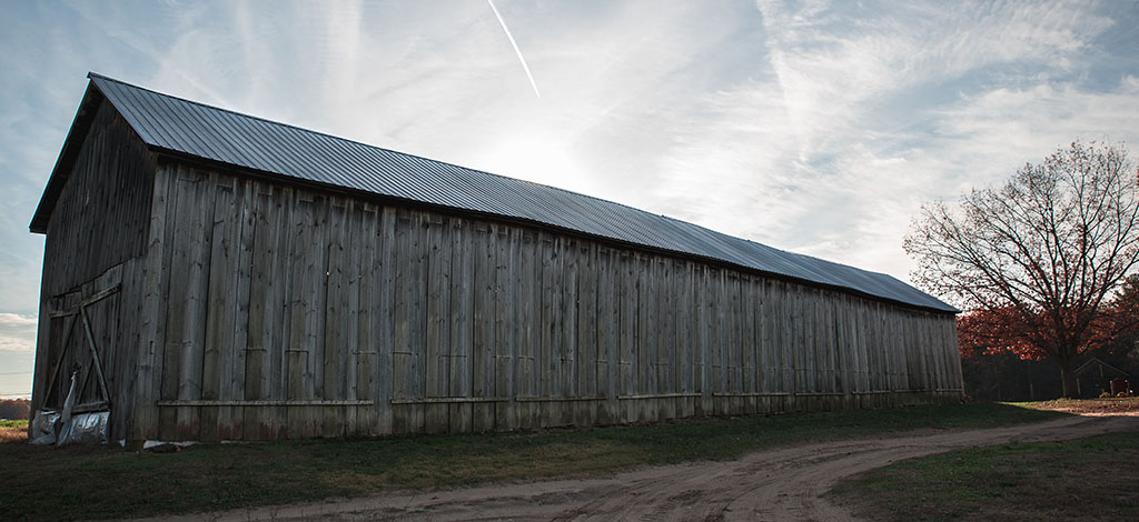 large barn with gray boards