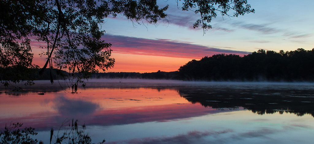 Sky reflects on evening lake Windsor CT